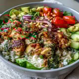 Savory Pesto Chicken Bowl piled high with vibrant marinated chicken, crisp cucumber and red onion, plus buttery avocado, ready to serve for a healthy family dinner.