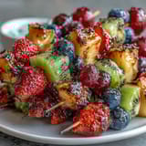 A platter of Rainbow Fruit Skewers with Honey Dip, featuring fresh, bite-sized fruits on wooden sticks, served alongside a creamy honey-yogurt dip for a healthy treat.