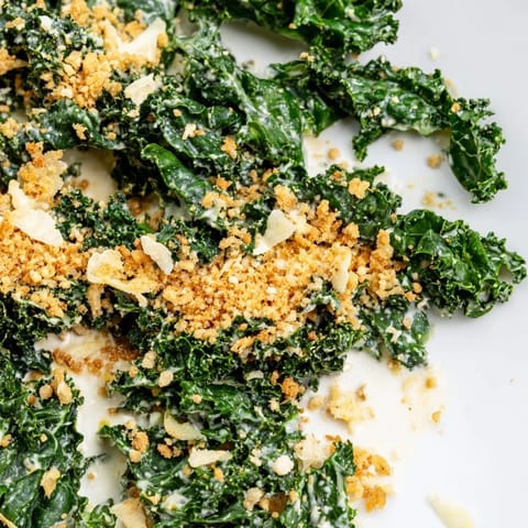 This Garlic Parmesan Kale Salad serves as a vibrant side dish or light vegetarian lunch, ready in just 20 minutes.