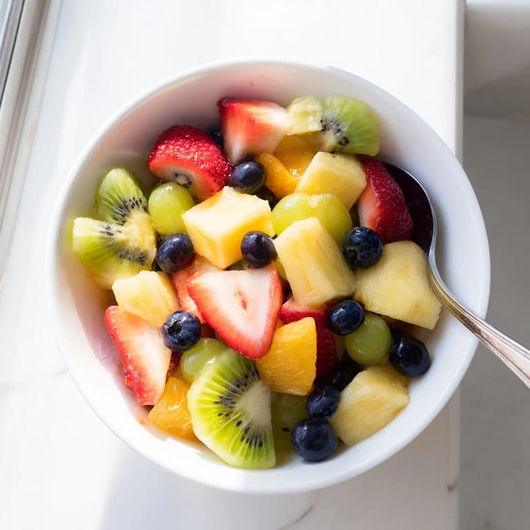 Colorful Fruit Salad featuring kiwi and blueberries, served fresh as a refreshing summer dessert.