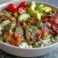 Chimichurri Chicken Bowl with juicy grilled chicken over fluffy rice and bright veggies.